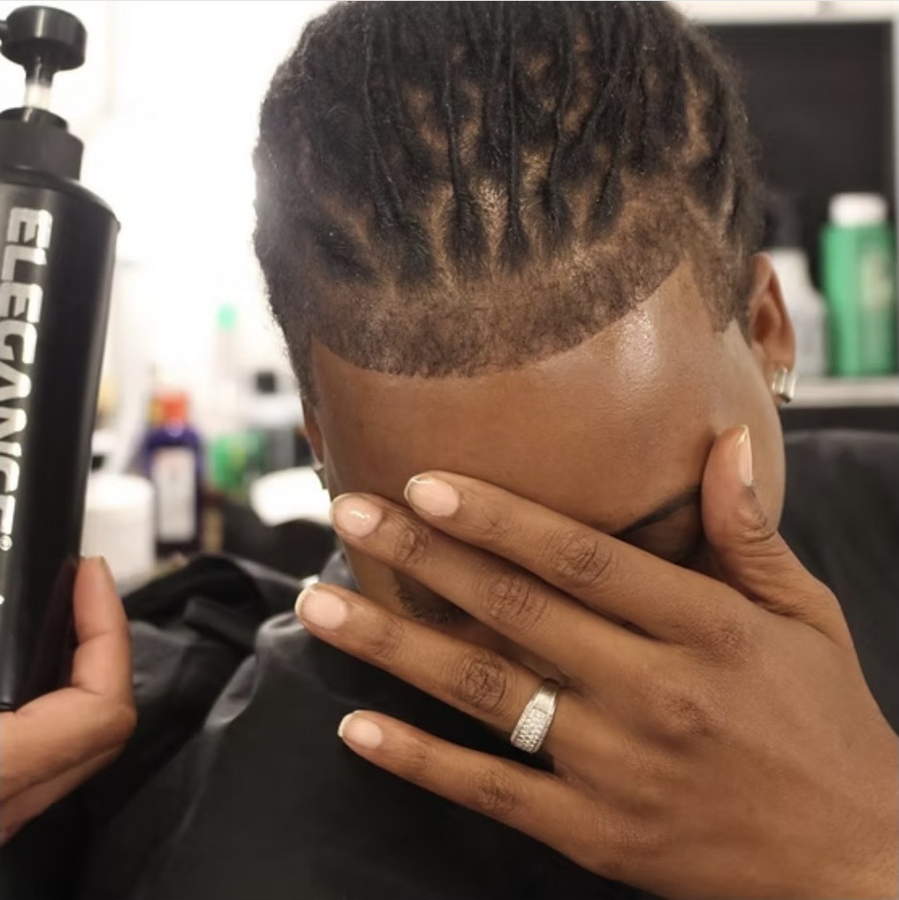 Crisp edge up on a client with short locs, finished with elegance spray